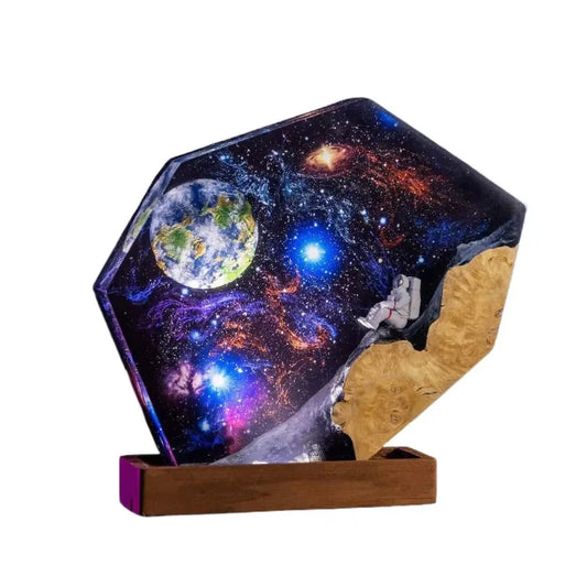 A plastic night light in the shape of a galaxy with wooden astronaut motifs.